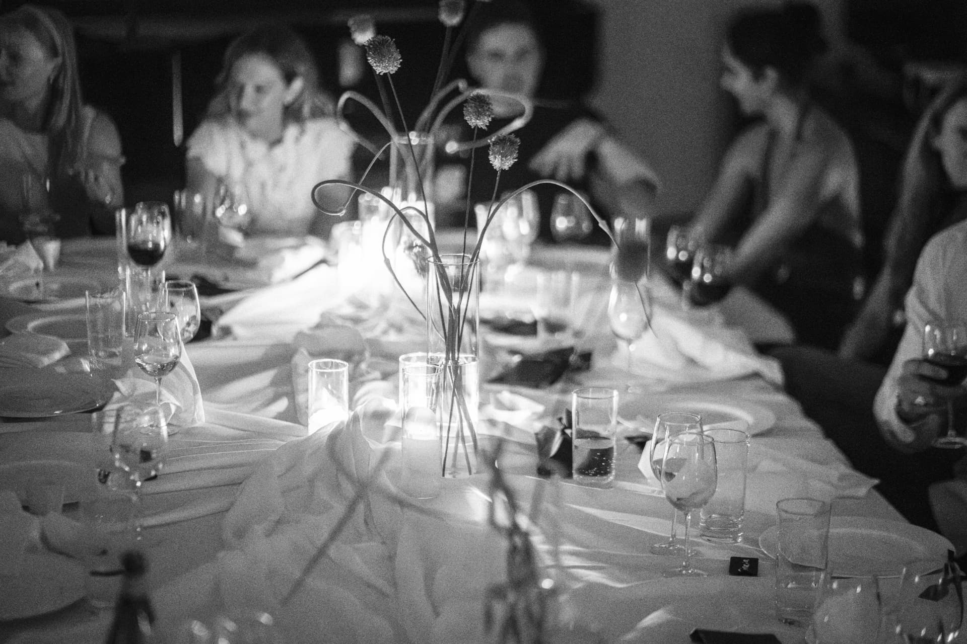 Guests gathered around an intimate candlelit Cureators dinner table